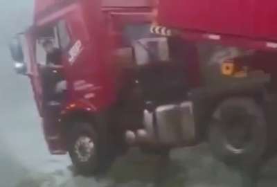 En un deslizamiento de tierra que provocó el colapso parcial del puente Houzi He en China, un camión estuvo a punto de caer al vacío.